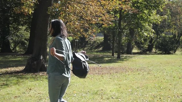 Happy young latin Woman is spinning in the Park - Sunny Autumn Day