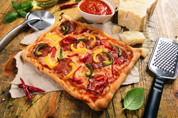 Homemade pizza with salami and pepper