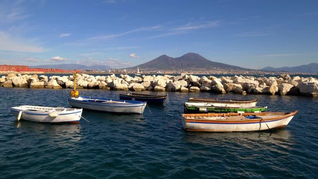 Colorful rowboats moored in the Gulf of Naples with Mount Vesuvius in the background, Naples, Italy