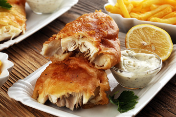 traditional British fish and chips consisting of fried fish, potato chips and mayonnaise