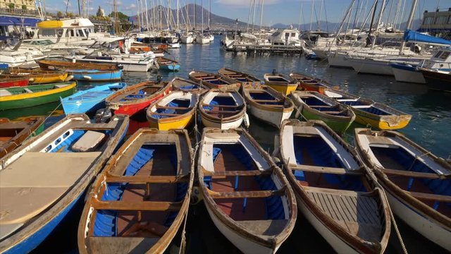 Colorful wooden rowboats moored in marina, Naples, Italy