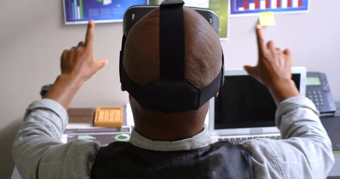 Businessman using virtual reality headset on desk in the office 4k