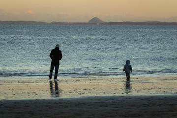 Father and son walking on Portobello Beach Edinburgh