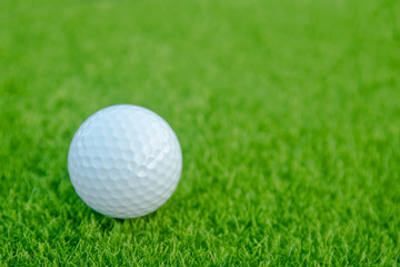 Golf ball on green grass ready to play at golf course. with copy space