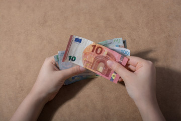 Hand holding American dollar  isolated on wooden background