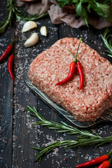 Raw meat with fresh herbs and pink Himalayan salt