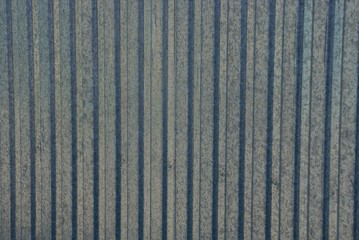 gray metal texture of a striped iron wall