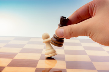 Person playing chess game making a move