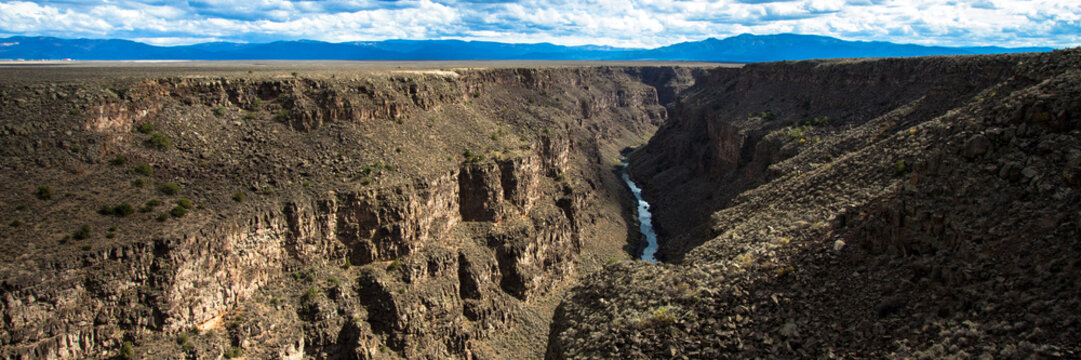 Panoramic view of the Rio Grande Gorge, looking south from the US Hwy 64 bridge over the 800' deep chasm, which lies on the Taos Plateau in New Mexico, paralling the Sangre de Cristo Mountains