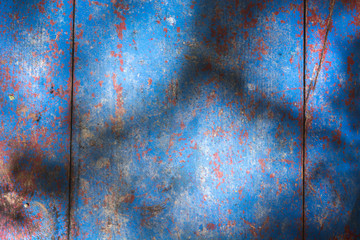 Old blue wooden table background texture with shadows over it