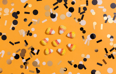 Halloween theme with candies on a orange background