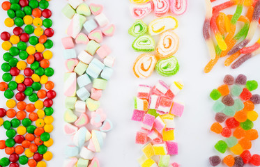 Creative arrangements of confectionery or candies on a white background. Flat lay.