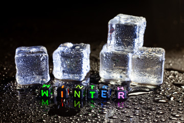 ice cubes reflection and Winter on black table background.