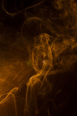 Gold smoke on black background.