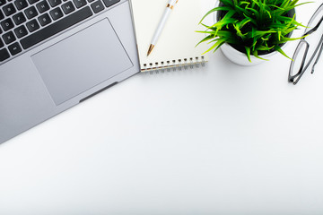 Stylish office table desk. Workspace with laptop, diary, succulent on white background. Flat lay, top view with copy space for text