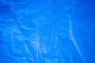 Crumpled blue paper background.