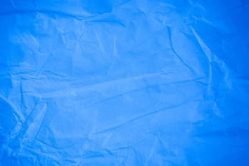 Crumpled blue paper background.