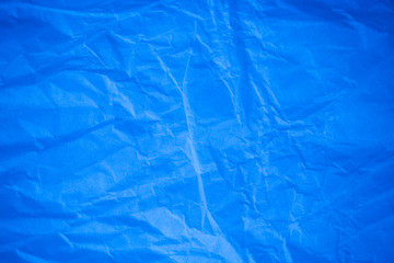 Crumpled blue paper background.