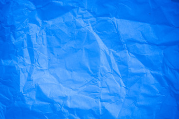 Crumpled blue paper background.