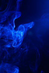Fototapeta premium Blue smoke on black background.