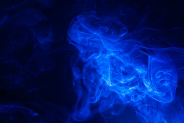 Blue smoke on black background.
