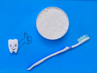 The figure shows the tooth class dentist the powder and the brush. The view from the top. Flat lay.