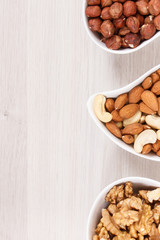 Various nuts and almonds containing healthy natural vitamins and minerals, nutritious eating, place for text