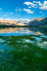 Obraz premium Very scenic and beautiful view of Nubra Valley mountians and reflection in water sunset in Ladakh