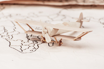 Fototapeta na wymiar Journey on a small toy wooden plane