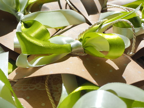 Handmade paper favors with green and white bow
