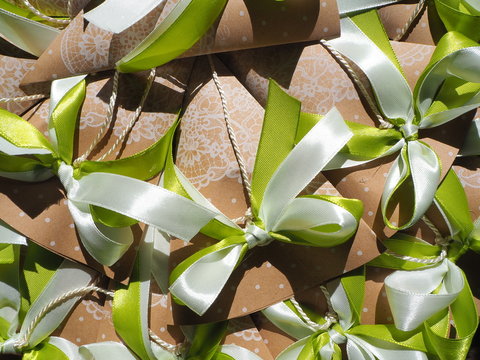 Handmade paper favors with green and white bow
