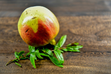 Pomegranate fruit with leaf on wood background
