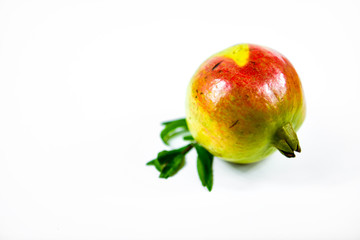 Pomegranate fruit with leaf on white background