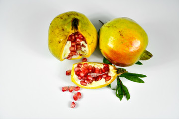 Pomegranate fruit with seeds on white background