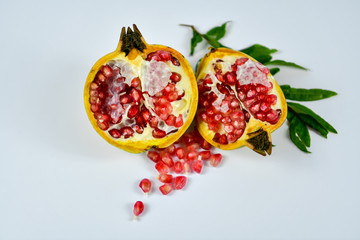 Pomegranate fruit with seeds on white background