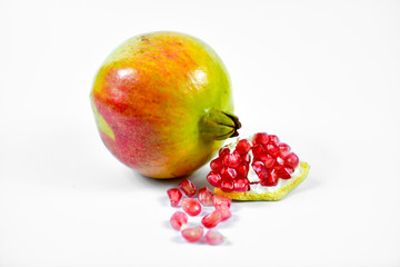 Pomegranate fruit with seeds on white background