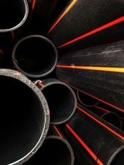 Pile of HDPE pipes conduit for underground electrical wiring in technology and construction...