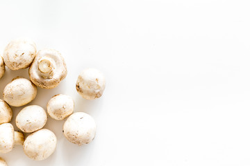 Mushroom champignons. Fresh raw whole champignons on white background top view copy space