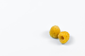Set of yellow raspberry berry fruits on white background.
