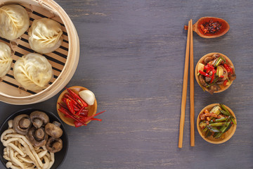 Dishes of Chinese cuisine in assortment. Steam dumplings, noodles, salads, vegetables, mushrooms, seafood. Top view. Copy space
