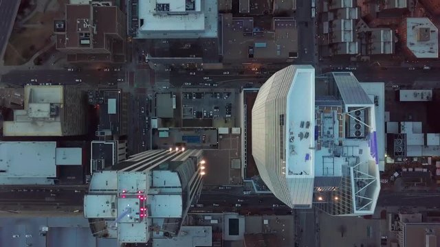 4K Aerial Drone Footage Overhead Skyscraper Buildings In Downtown CIty Denver Colorado with A Birds eye view of people and traffic commuting during sunset