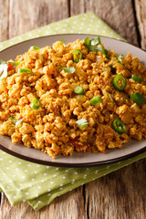 Karahi Chicken Keema dish which is a medley of onion, tomatoes, spices and chicken minced close-up on a plate. Vertical