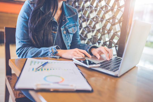 Hand of a woman working on a laptop computer. Business Graph Analysis