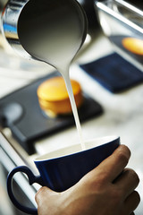 Pouring milk to make latte art 