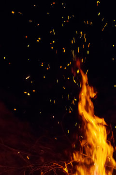 Night bonfire with sparks. Fire background with copyspace