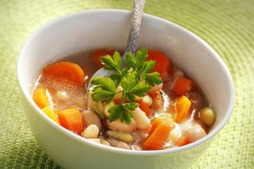 Bowl of white bean soup with parsley