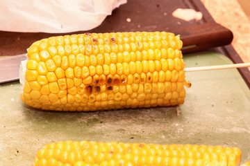 Grilled corn on the grill. Cooking food on the street