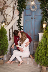 young couple in front of christmas tree