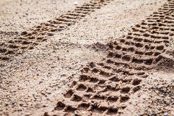 motorcycle tire track print on sand with selective focus