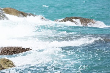 Sea Waves in ocean wave Splashing Ripple Water. Blue water background. Pound stone Rough water pounding granite rocks and coast. Sea wave and strong winds. nature island	